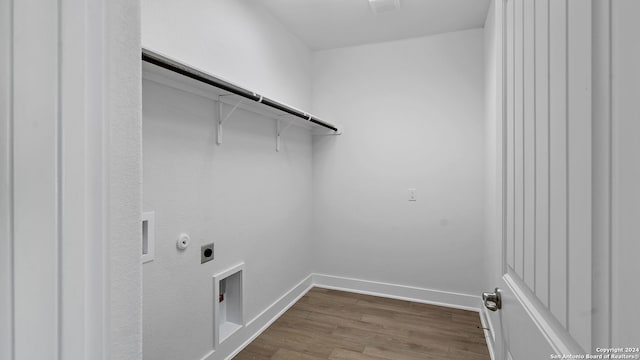 washroom with gas dryer hookup, hookup for an electric dryer, and wood-type flooring