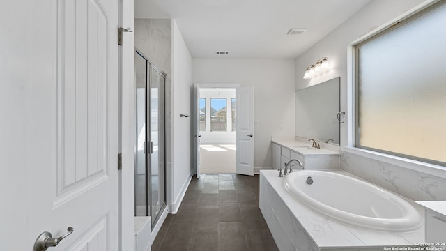 bathroom with vanity and independent shower and bath