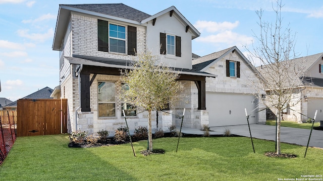 view of front of home with a front lawn and a garage