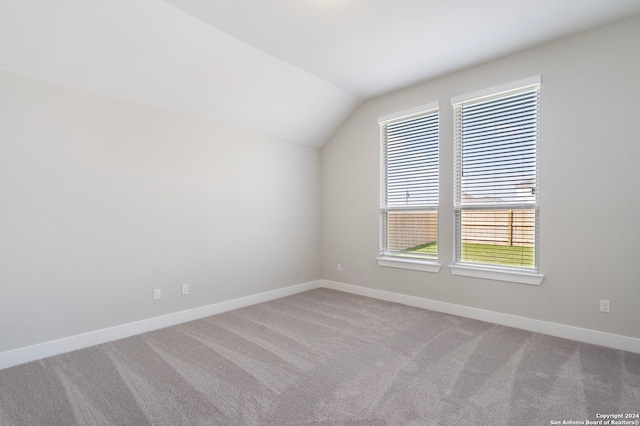 bonus room with carpet floors and vaulted ceiling