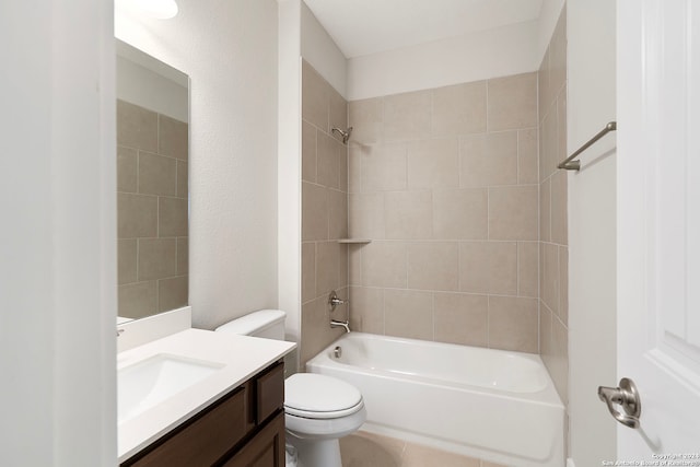 full bathroom featuring tiled shower / bath combo, vanity, and toilet