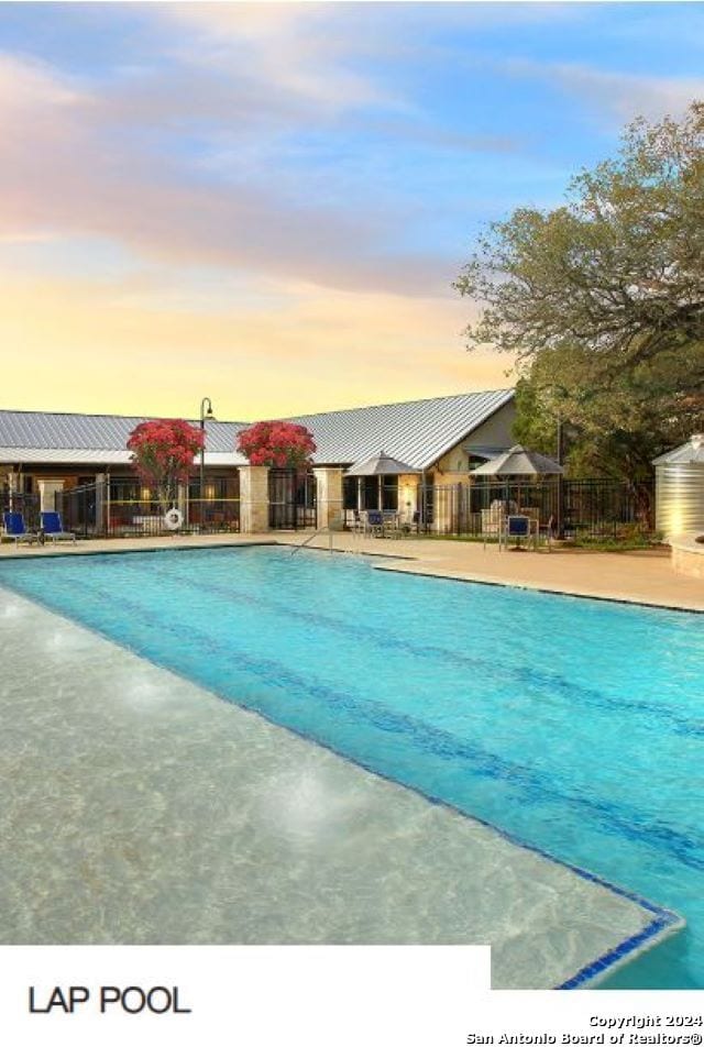 view of pool at dusk