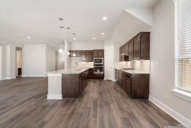 kitchen with sink, decorative light fixtures, a kitchen island with sink, appliances with stainless steel finishes, and dark hardwood / wood-style floors