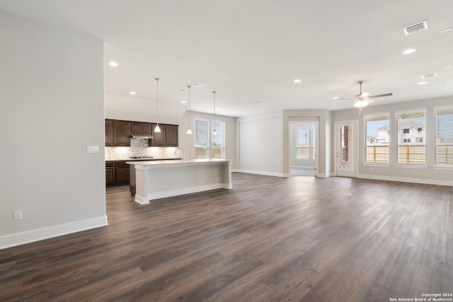 unfurnished living room with dark wood-type flooring and ceiling fan