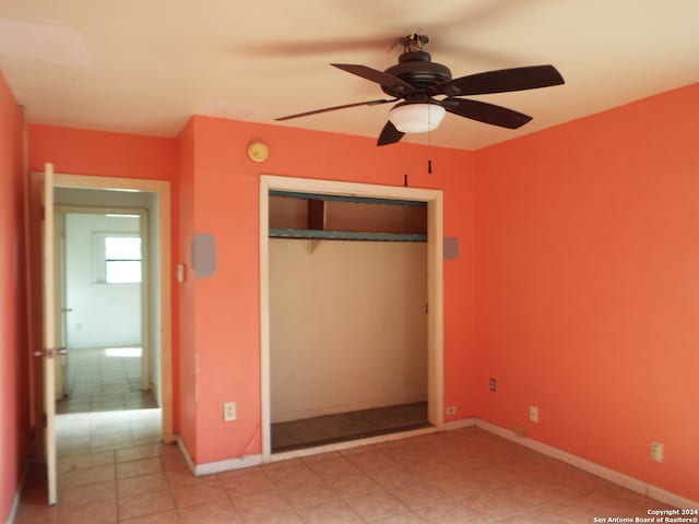 unfurnished bedroom with a closet and ceiling fan