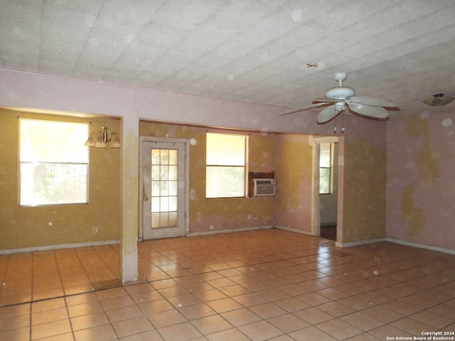 tiled spare room featuring ceiling fan