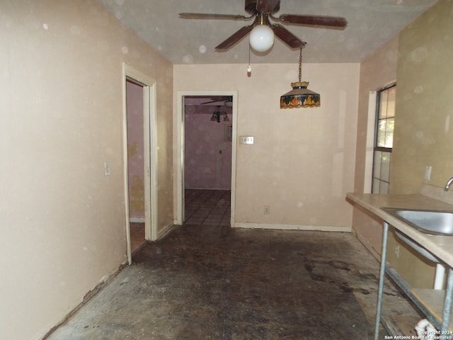 unfurnished dining area featuring ceiling fan and sink