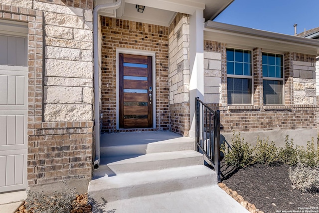 property entrance featuring brick siding