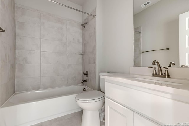 full bathroom featuring vanity, toilet, tile patterned floors, and tiled shower / bath