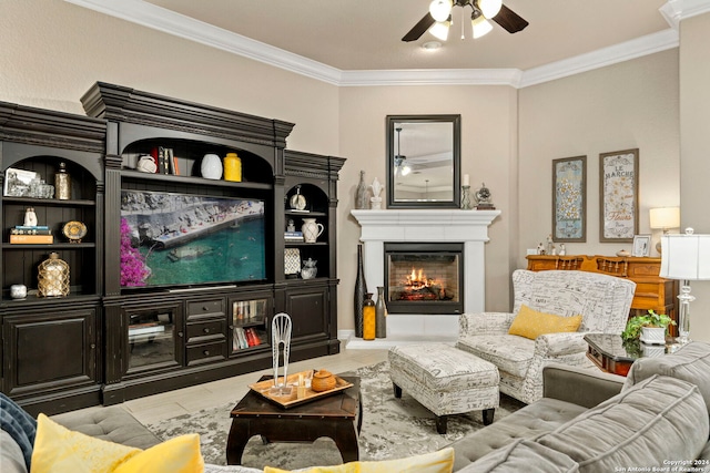 living room featuring crown molding, a glass covered fireplace, and ceiling fan