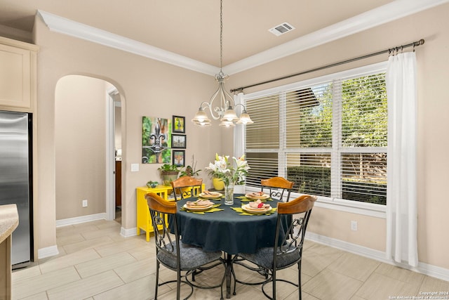 dining area featuring visible vents, crown molding, baseboards, a chandelier, and arched walkways