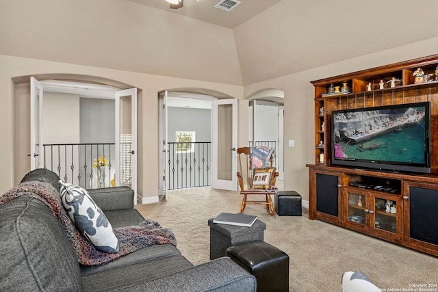 living area with visible vents, lofted ceiling, carpet flooring, baseboards, and arched walkways