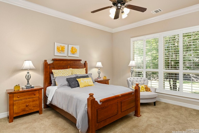 carpeted bedroom featuring crown molding and ceiling fan