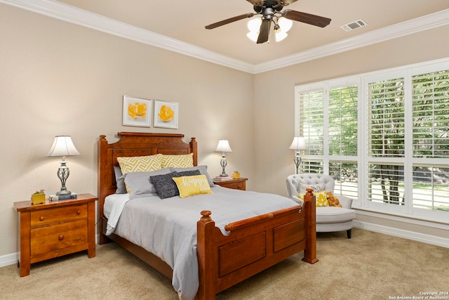 bedroom featuring visible vents, ornamental molding, baseboards, ceiling fan, and carpet flooring