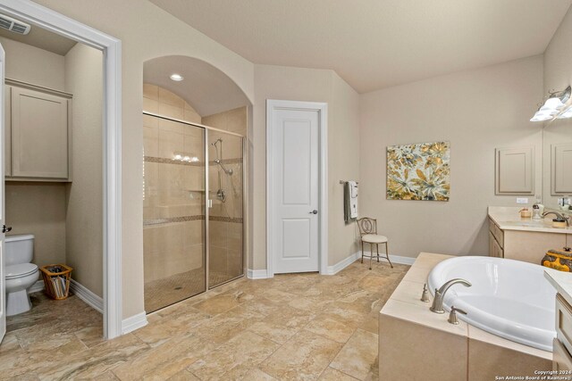 full bath featuring vanity, toilet, a shower stall, visible vents, and a garden tub