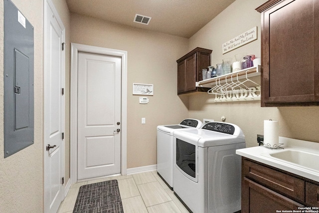 washroom with cabinets, washer and dryer, electric panel, and light tile patterned flooring