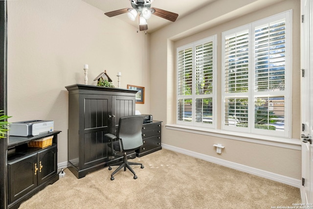 carpeted office space featuring ceiling fan and a healthy amount of sunlight