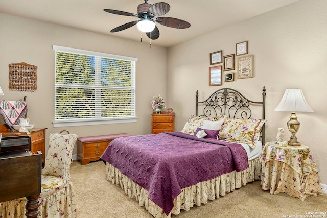 carpeted bedroom with baseboards and a ceiling fan