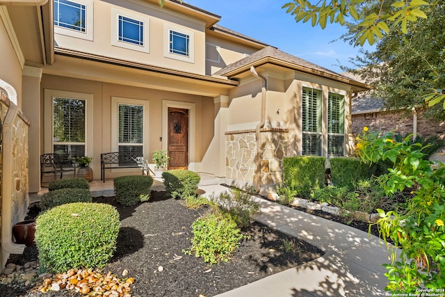 view of exterior entry with a porch