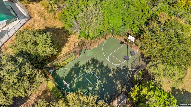 view of sport court with basketball court and fence