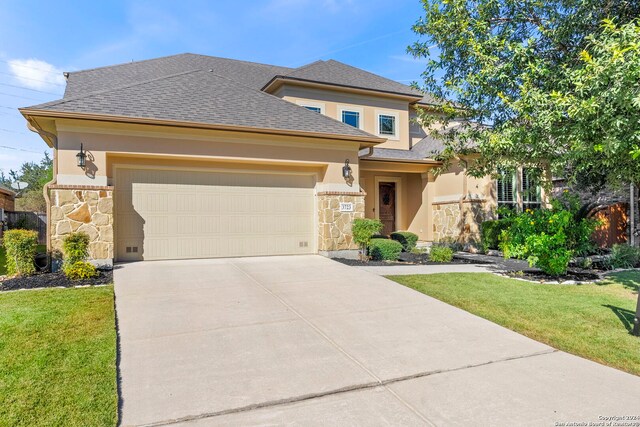 prairie-style house featuring an attached garage, a front lawn, stone siding, stucco siding, and driveway