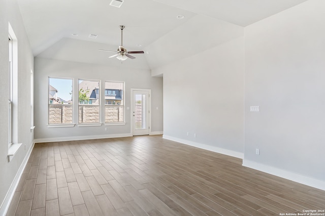 spare room with hardwood / wood-style flooring, ceiling fan, and lofted ceiling