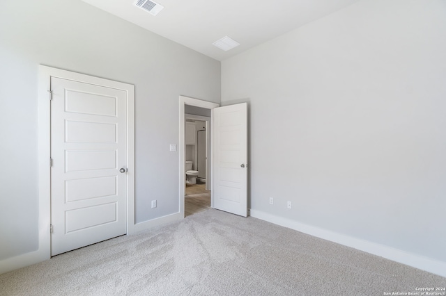 unfurnished bedroom with light carpet