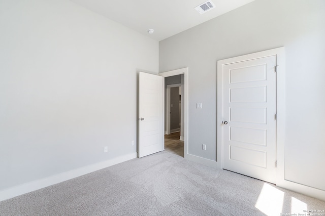 unfurnished bedroom featuring light carpet