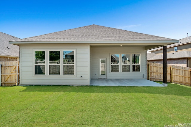 back of property featuring a yard and a patio