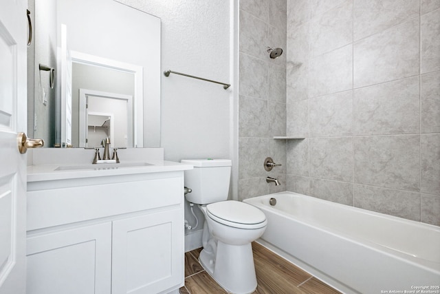 full bathroom with vanity, toilet, and tiled shower / bath