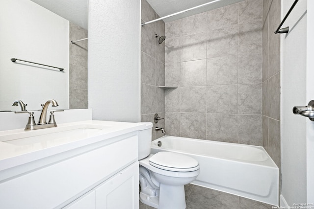 full bathroom featuring vanity, tiled shower / bath combo, tile patterned floors, and toilet