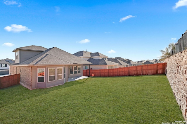 rear view of house with a yard