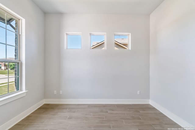 empty room featuring light hardwood / wood-style flooring and plenty of natural light