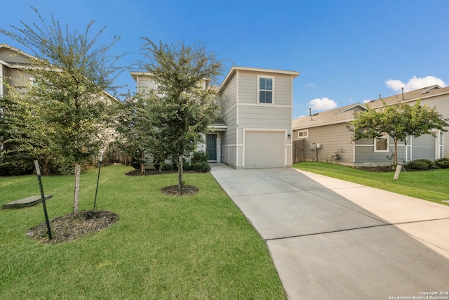 view of front of house featuring a garage and a front lawn