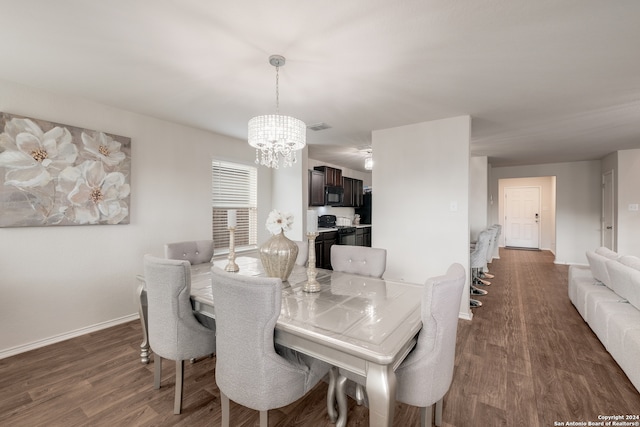 dining room featuring a notable chandelier and dark hardwood / wood-style floors