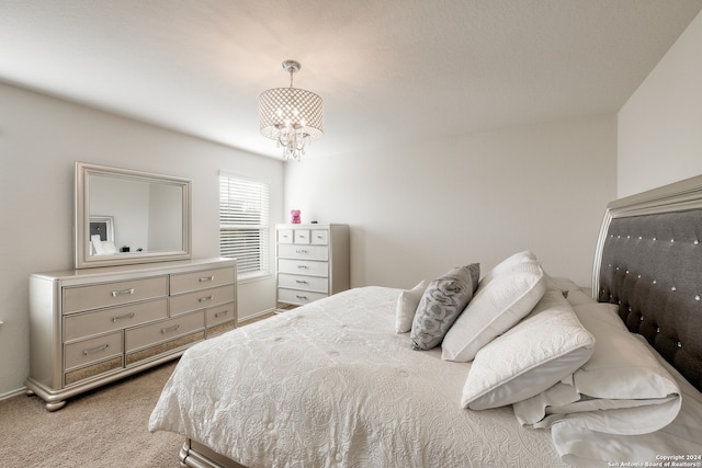 carpeted bedroom with an inviting chandelier