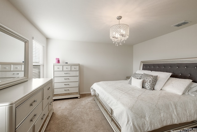 carpeted bedroom with a notable chandelier