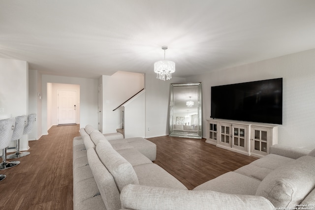 living room with a chandelier and dark hardwood / wood-style flooring