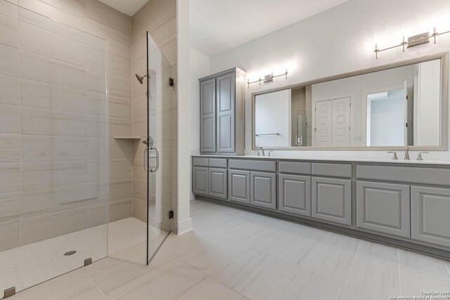 bathroom with vanity and a shower with door