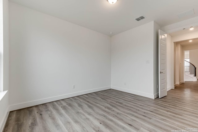 unfurnished room with light wood-type flooring