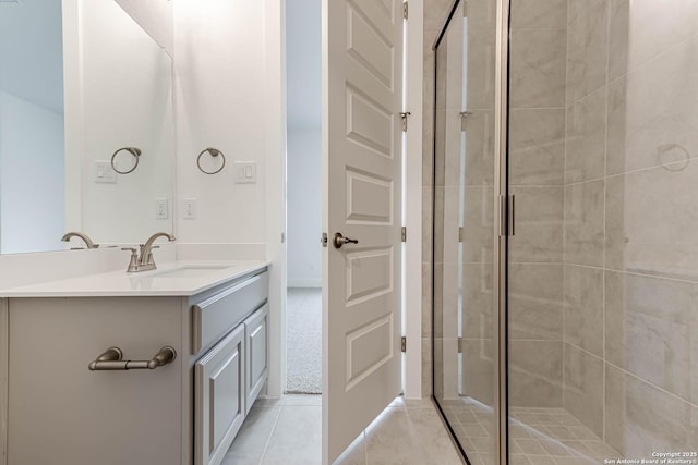 bathroom featuring walk in shower, tile patterned floors, and vanity