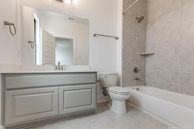 full bathroom featuring tiled shower / bath combo, vanity, tile patterned flooring, and toilet