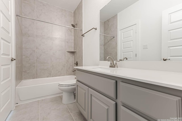 full bathroom featuring tiled shower / bath combo, vanity, tile patterned floors, and toilet