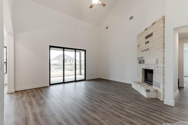 unfurnished living room featuring hardwood / wood-style flooring, a fireplace, high vaulted ceiling, and ceiling fan