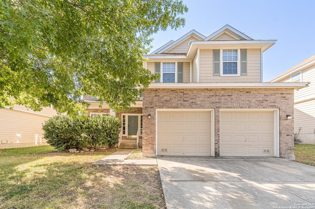 view of front of property with a front yard and a garage