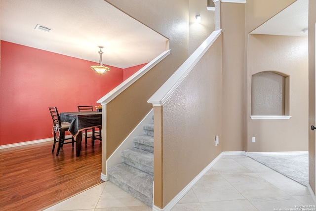 stairway featuring wood-type flooring