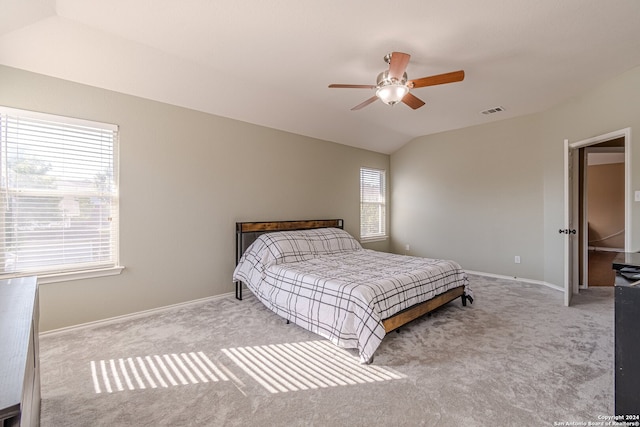 bedroom with lofted ceiling, ceiling fan, and light colored carpet