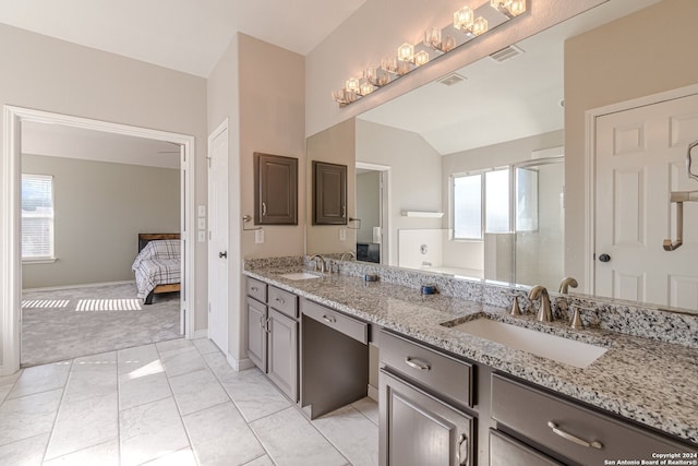 bathroom with an enclosed shower, vaulted ceiling, tile patterned floors, and vanity