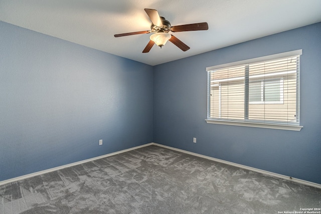 carpeted spare room featuring ceiling fan