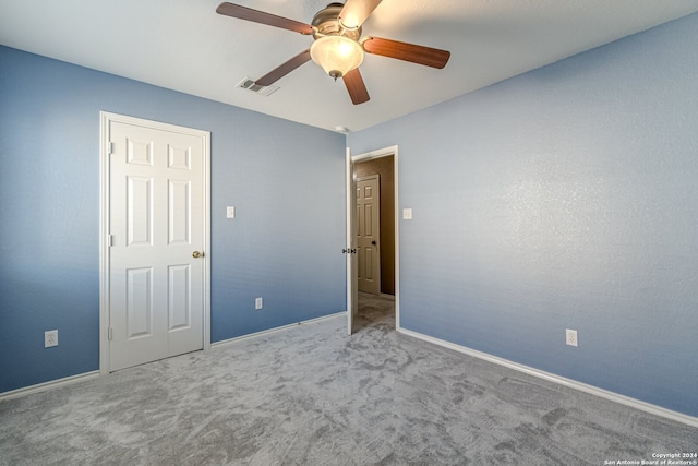 unfurnished bedroom with ceiling fan and light carpet